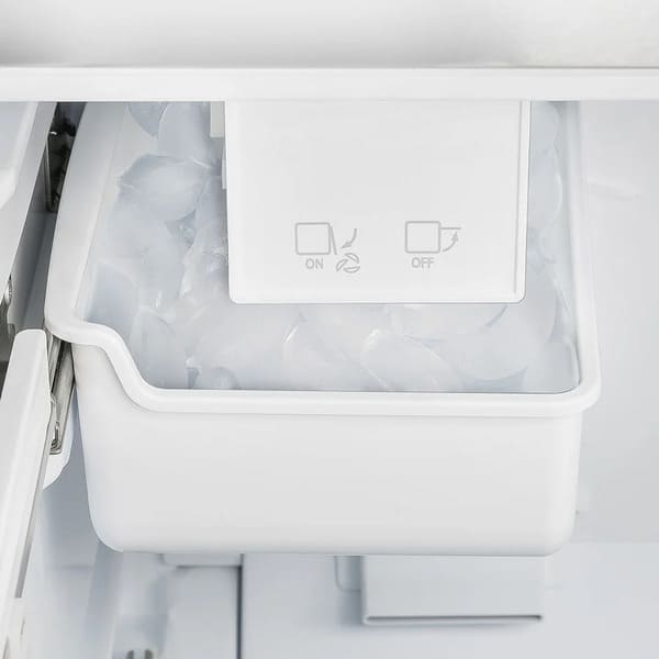 Close-up view of the built-in ice maker inside the FORNO 30-inch French door refrigerator from the 2-Piece Appliance Package, featuring a compact design with a clear ice bin—providing convenient, automatic ice production for everyday use.