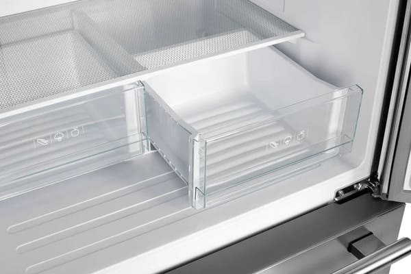 Interior view of the Forno 30-inch French door refrigerator in stainless steel, highlighting the clear crisper drawers designed to keep fruits and vegetables fresh with easy visibility and smooth-slide functionality.