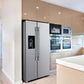 Lifestyle view of the FORNO 36-inch refrigerator with water dispenser in stainless steel, integrated into a modern kitchen environment with surrounding cabinetry and decor.