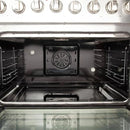 Interior view of the FORNO 36-inch gas range convection oven, featuring multiple racks and a powerful convection fan for even heat distribution.