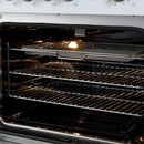 Close-up of the air fryer basket inside the FORNO Giovanni 30-Inch Gas Range in white, highlighting the stainless steel accessory set within the blue enamel convection oven interior.
