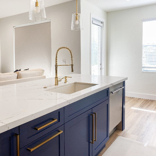 The ZLINE Dishwasher placed in a marble and blue themed kitchen